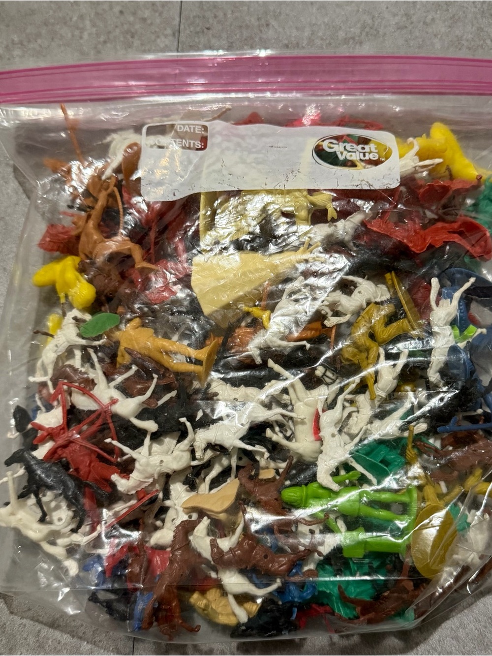 Bag of Assorted Toy Cowboys, Indians, and horses.